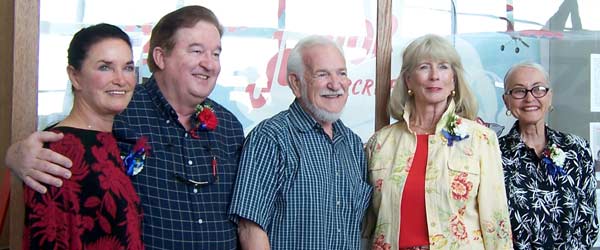 Valerie Alexander, Bill Walker, Frank Macy, Joan Anderson, Marilyn Portwood all pose in front of the Jim Walker exhibit